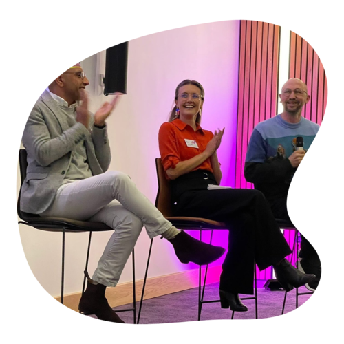 A conference panel with 3 people in discussion