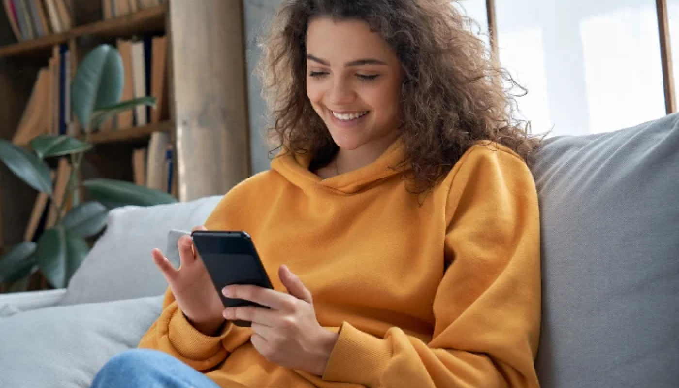 Teenage girl accessing Trial Flow on her smart phone